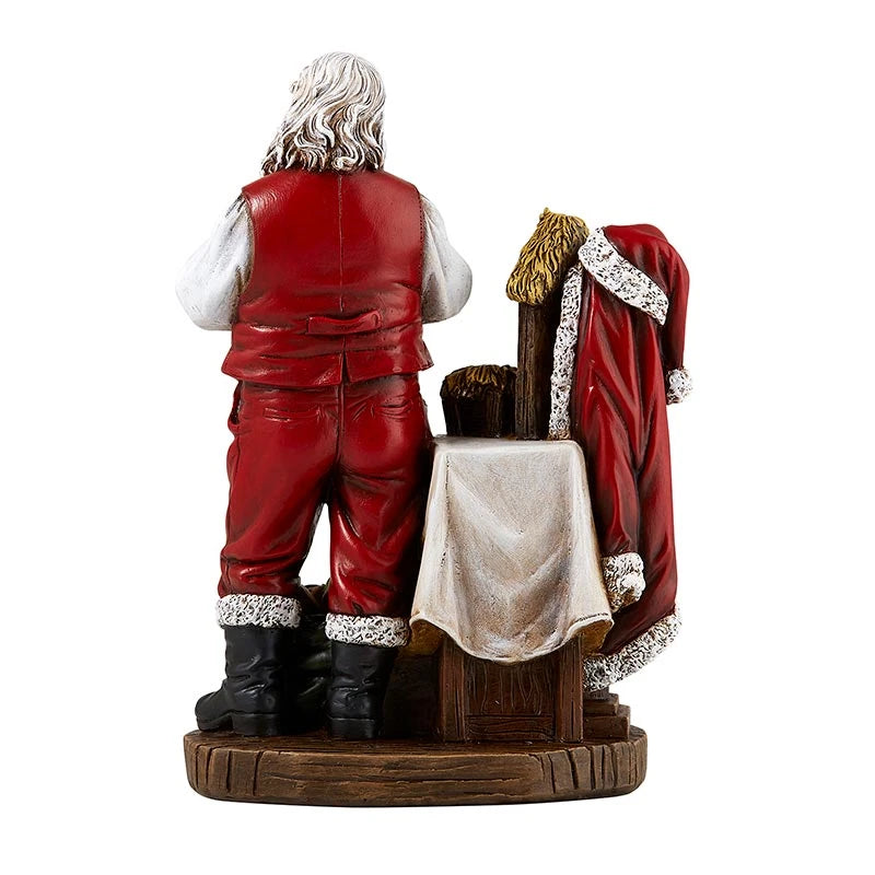Religious Christmas figurine featuring Santa reverently adoring the Christ Child.