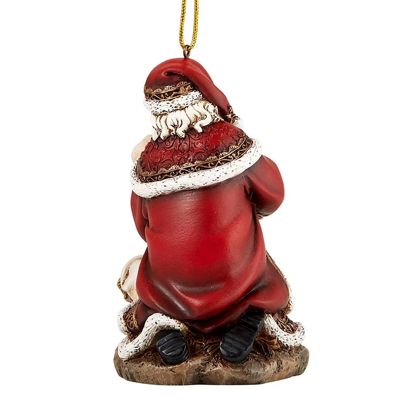 Religious Christmas ornament with Santa reverently adoring the Christ Child.