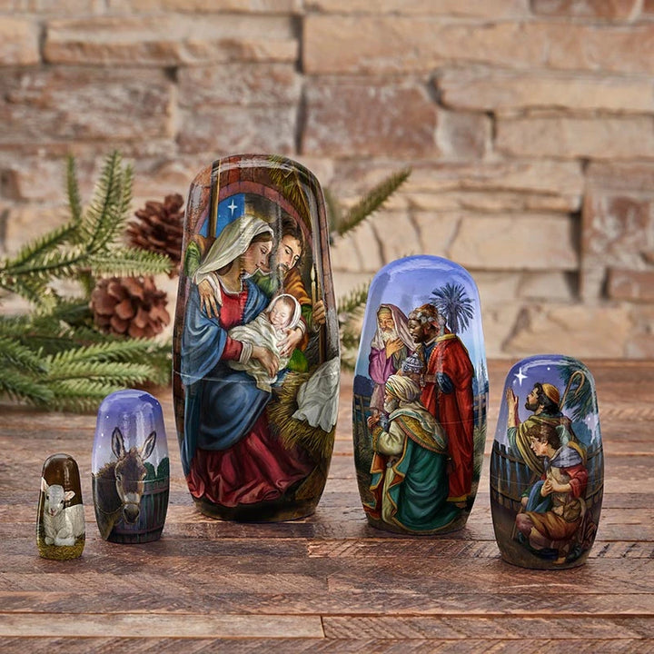 Catholic nesting Nativity dolls with Holy Family, Wise Men, shepherds, donkey, and Lamb of God imagery.
